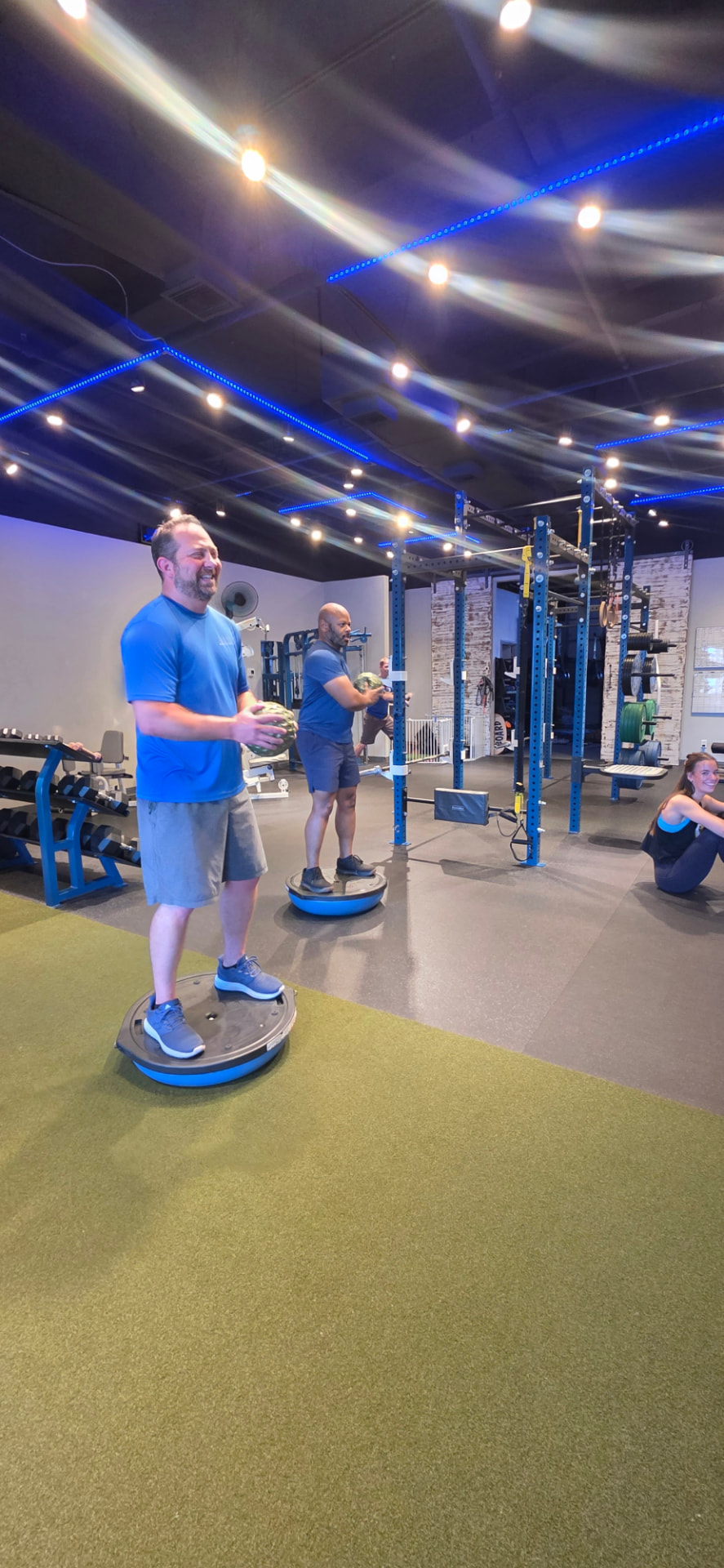 Adults doing balance training on BOSU trainers at Everybitfit in Scottsdale