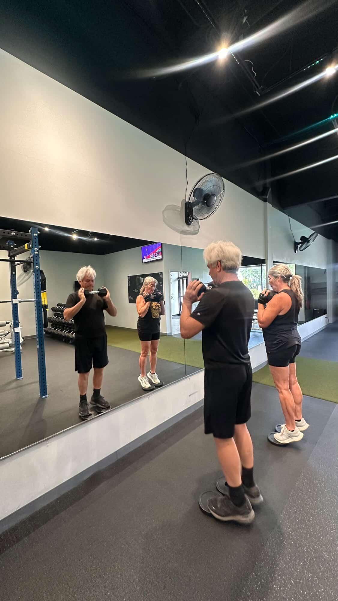 Couple doing dumbbell strength work together at the Everybitfit studio in Scottsdale