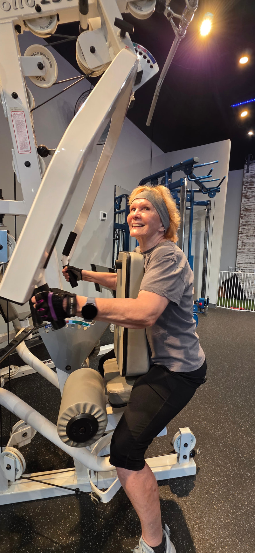 Senior member building bone density on a strength machine at Everybitfit